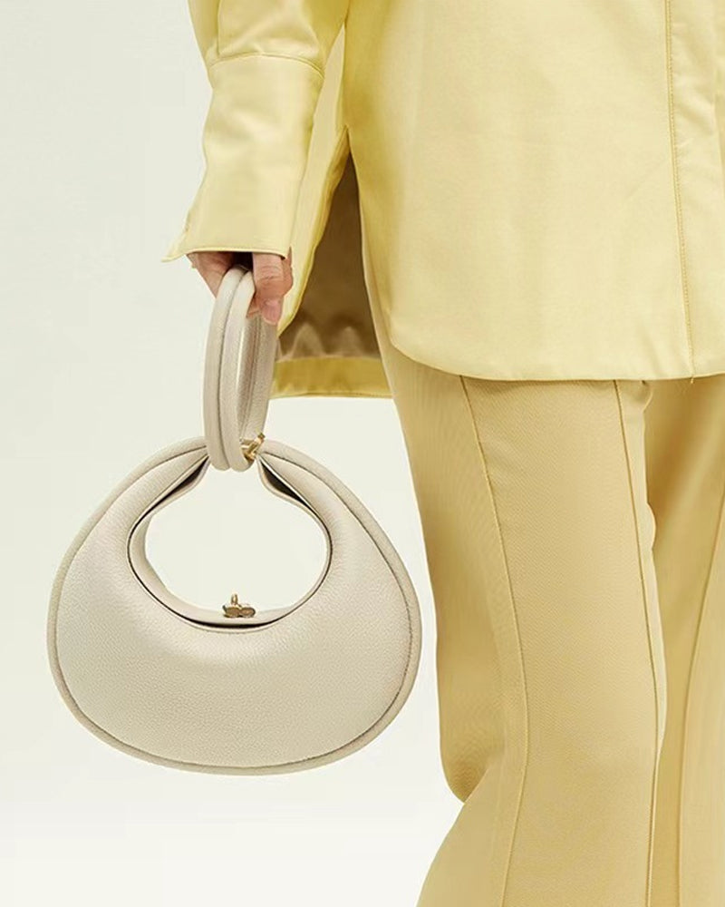 Effen kleur elegante halvemaanvormige schoudertas onder de arm