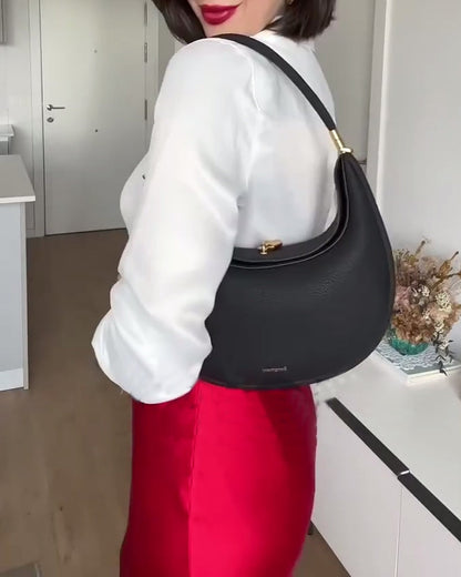 Effen kleur elegante halvemaanvormige schoudertas onder de arm