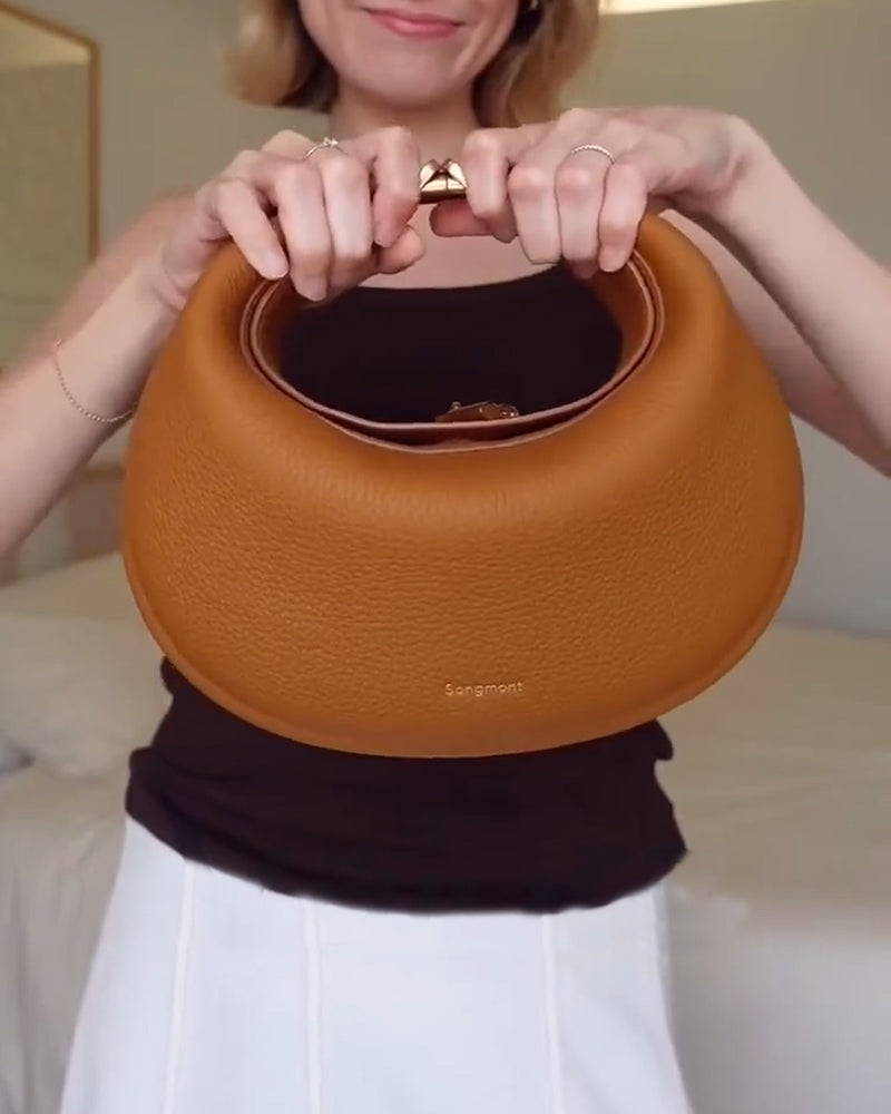 Effen kleur elegante halvemaanvormige schoudertas onder de arm